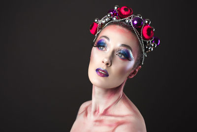 Portrait of mature woman against black background