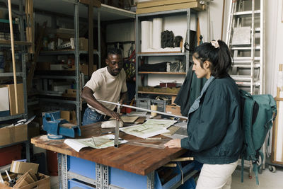 Rear view of man working in library