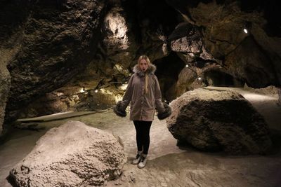 Portrait of young woman standing in cave