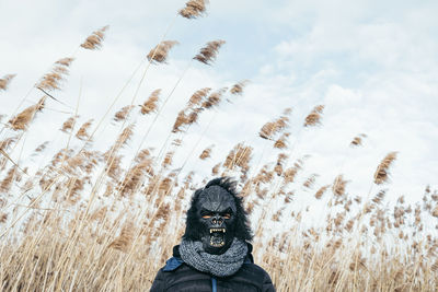 Person wearing mask against plants