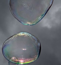 Close-up of bubbles in rainbow against sky
