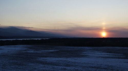 Scenic view of landscape against sky during sunset