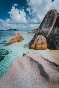 Scenic view of rocks on beach against sky