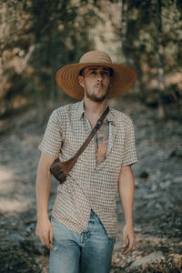 Portrait of man wearing hat while standing on land