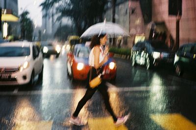 Blurred motion of cars on city street during rainy season