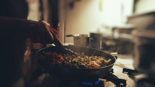 Midsection of woman making food in kitchen