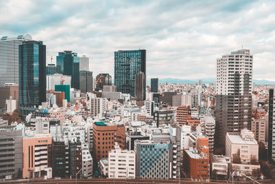 Modern buildings in city against sky