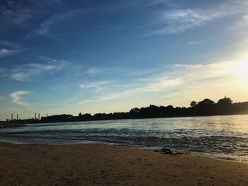 Scenic view of beach against sky during sunset