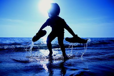 Man on sea shore against sky