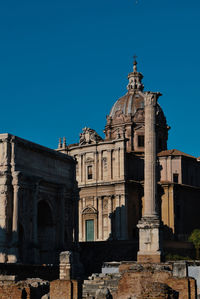 Low angle view of historical building against clear blue sky