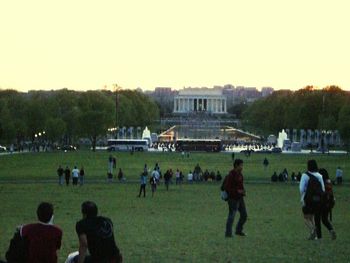 People relaxing on grassy field