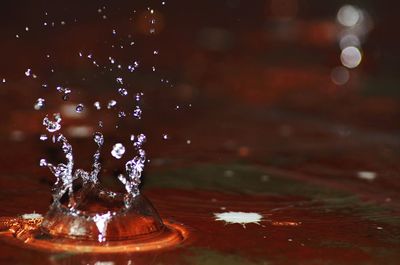 Close-up of water splashing on table