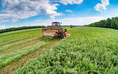 Fish-eye lens view of agricultural machineries at farm