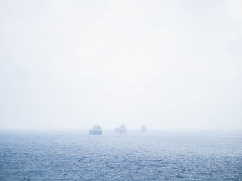 Boat sailing in sea against sky