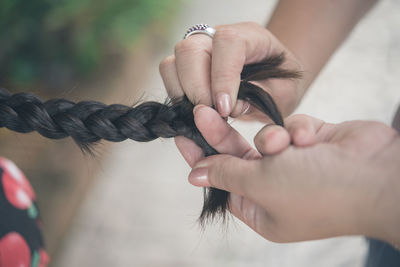 Close-up of woman braiding hair