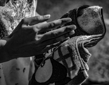 Close-up of man hands on rock