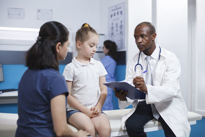 Doctor examining patient at clinic