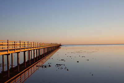 Scenic view of sea against clear sky at sunset