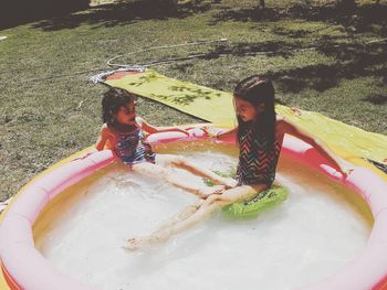High angle view of girl and ice cream in water