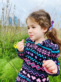 Portrait of young woman standing on field