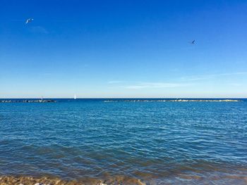 Scenic view of sea against blue sky