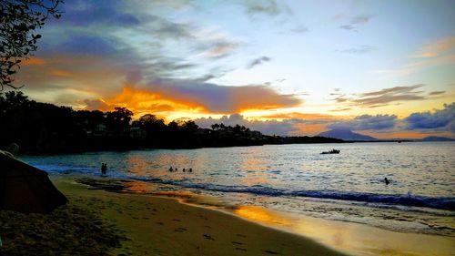 Scenic view of beach against sky during sunset