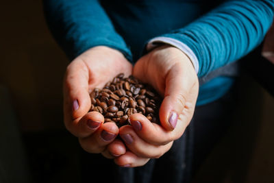 Midsection of woman holding coffee beans