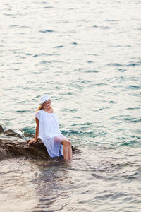 Woman sitting in sea