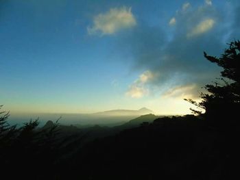 Scenic view of silhouette mountains against sky