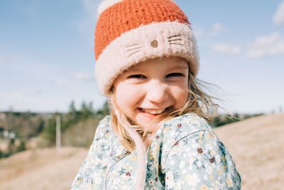 Portrait of a young girl smiling with her hair blowing in the wind