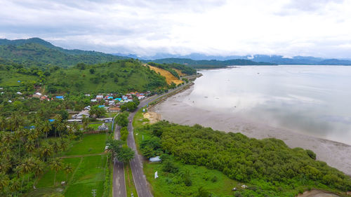 High angle view of trees and sea against sky