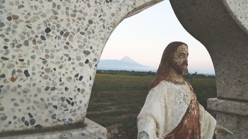 Old jesus christ sculpture under archway