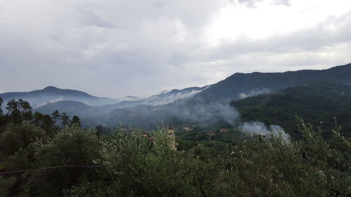 Scenic view of mountains against cloudy sky