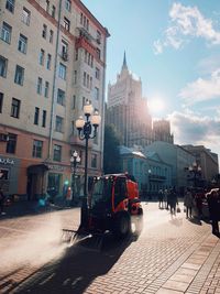 City street and buildings against sky