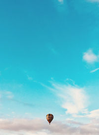 Low angle view of hot air balloon against blue sky