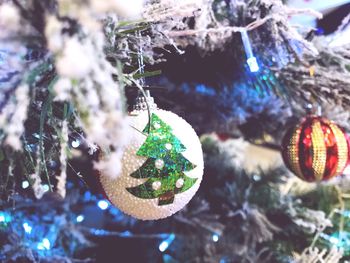 Close-up of christmas decorations hanging on tree