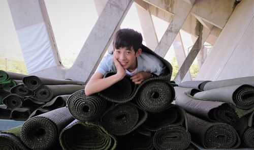 Portrait of boy lying down with head on hand