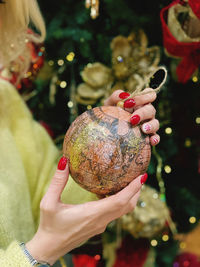 Midsection of woman holding christmas tree