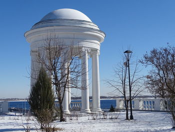 Low angle view of water tower against clear blue sky