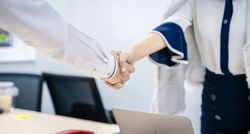 Business people shake hands to finish the meeting , hand in hand to work together