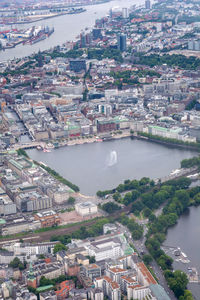 High angle view of illuminated city by river