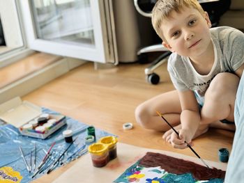 High angle view of boy playing with toy blocks at home