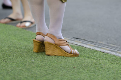 Low section of woman standing on carpet