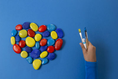 Close-up of human hand against blue background