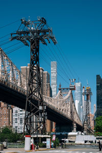 Low angle view of crane bridge against clear blue sky