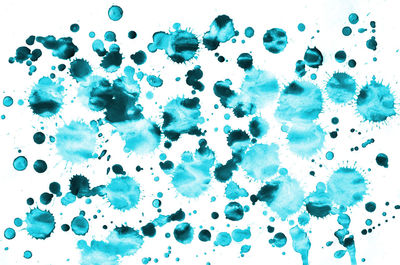 Close-up of bubbles over white background