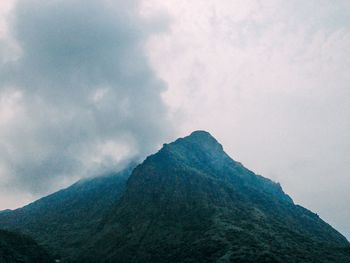 Low angle view of volcanic mountain against sky