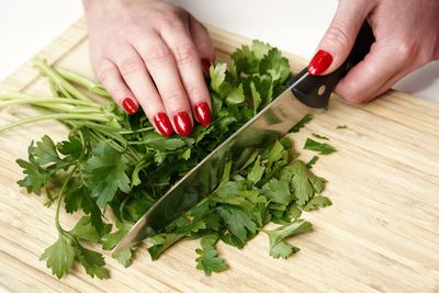 Midsection of person holding vegetables