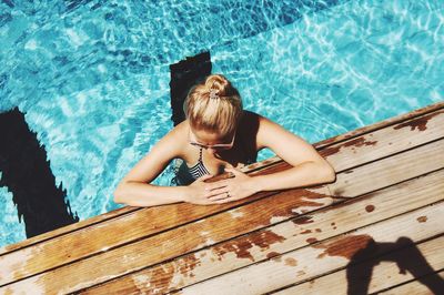 High angle view of woman sitting in swimming pool