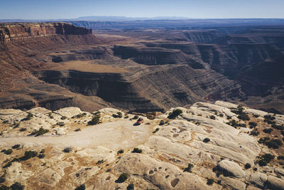 Aerial view of a car on a cliff of a utah canyon
